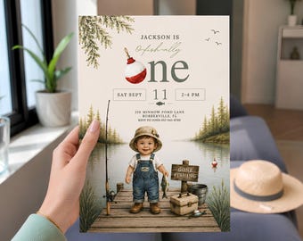 May include: A rectangular invitation card featuring a watercolor-style illustration of a child in overalls and a bucket hat standing on a wooden dock. The text reads: JACKSON IS O-fish-ally one, SAT SEPT 11, 2-4 PM, 210 MINNOW POND LANE, BOBBERVILLE, FL.
