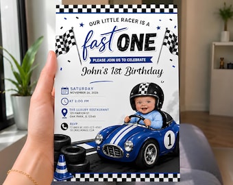 May include: A birthday invitation card featuring a race car theme with a checkered border. The text reads: Our little racer is a fast one, please join us to celebrate John's 1st Birthday, Saturday November 26, 2026, at 2:00 PM, The Luxury Restaurant.