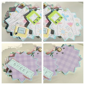 May include: A scrapbook with a light blue, pink, and white color scheme. The scrapbook has a starburst shape and features a variety of decorative elements, including flowers, butterflies, and stars. The scrapbook also includes a small tag with the word "precious" written on it.