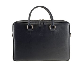 May include: A navy blue leather briefcase with a top handle and a rectangular shape. The bag has a zipper closure and silver-colored hardware. The briefcase is designed for carrying documents and other essentials.