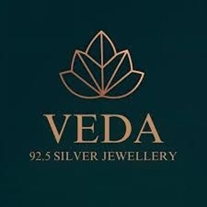 A brand logo featuring a stylized geometric lotus flower in gold above the text Veda 92.5 Silver Jewellery.