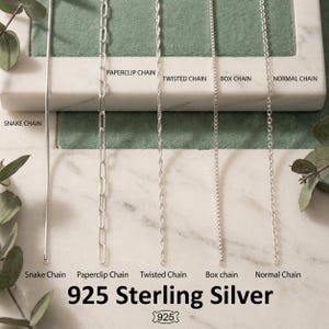May include: A display of five different 925 sterling silver chain styles: snake, paperclip, twisted, box, and normal. The chains are arranged vertically against a marble and green backdrop. The text "925 Sterling Silver" is displayed at the bottom.