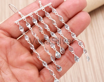 Brincos pendentes de prata esterlina com topázio azul natural, estilo geométrico circular.