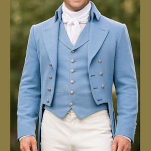 May include: A light blue formal jacket with a matching vest and white trousers. The jacket has a double-breasted design with gold buttons. The vest has a single-breasted design with matching buttons. A white ascot completes the look.