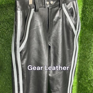 May include: A white ceramic mug with a black handle and the text "But First, Coffee" in a black, bold font. The mug is on a white surface.