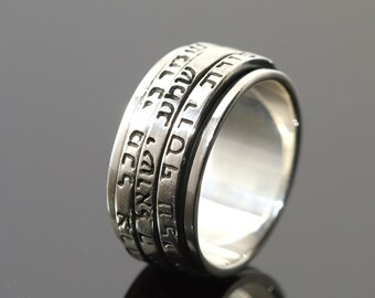 May include: A silver spinning ring with Hebrew text engraved on the band.