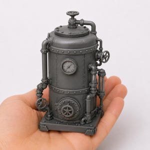 May include: A small, gray, cylindrical industrial boiler model featuring intricate piping, a circular pressure gauge, a round access hatch with a wheel handle, and several smaller control valves attached to the exterior of the main tank structure.