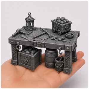 May include: Miniature gray workshop scene with a table, tools, and coal. Includes a lantern, pickaxe, hammer, and a cart filled with coal. A barrel and bucket are also present, creating a detailed, fantasy-themed diorama.