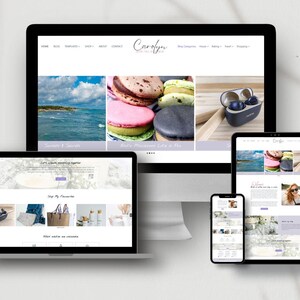 May include: A desktop computer monitor, a laptop, a tablet, and a smartphone displaying a website titled Carolyn. The screens show various layouts featuring images of ocean waves, colorful macarons, and small electronic devices on white backgrounds.