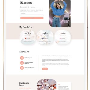 May include: A website design displayed on a tablet. The site features a light pink and white color scheme with sections for "Blossom", "My Socials", "About Me", and "Customer Love". The site includes social media follower counts and a photo of a person.