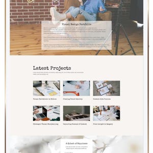 May include: A digital tablet displaying a website with a "Visual Design Portfolio" header. The website showcases "Latest Projects" with image thumbnails and a call to action. A person is visible in the background.