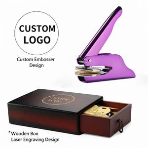May include: A purple custom embosser with a wooden box. The embosser has a long handle and a circular base. The wooden box has a drawer with a key inside. The text "CUSTOM LOGO" is displayed on the box and in a circle above the embosser.