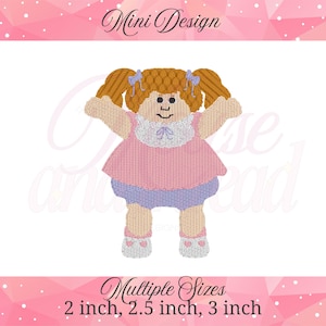 May include: Embroidered doll design with a pink dress, blue shorts, and pigtails. The doll has a white collar and heart-shaped accents on the shoes. The text "Mini Design" is at the top, and "Multiple Sizes" with size options are at the bottom.