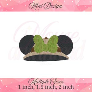 May include: A safari-style hat with black mouse ears and a green bow. The hat is tan and brown with a black brim. The text "Mini Design" is at the top, and "Multiple Sizes" with size options are at the bottom.