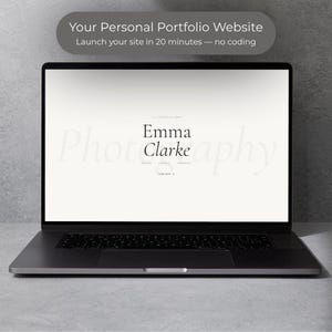 May include: A dark gray laptop displays a website with the name "Emma Clarke" in a minimalist design. The screen shows the text "Your Personal Portfolio Website" and "Launch your site in 20 minutes - no coding."