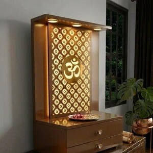 May include: A brown wooden home temple featuring a backlit back panel with a repeating floral pattern and a central Om symbol. The structure includes a top shelf with integrated lighting, a flat surface for offerings, and two drawers with knobs.