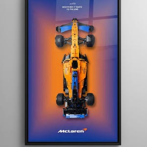 May include: Framed poster featuring a top-down view of a McLaren Formula 1 race car. The car is primarily orange and blue, set against a gradient background of orange and blue. The McLaren logo is at the bottom.