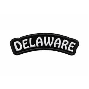 May include: A black and white patch with the word "DELAWARE" in white, arched across the center. The patch has a black border and a white background.
