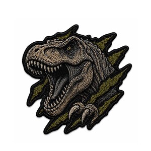 May include: Embroidered patch featuring a detailed Tyrannosaurus Rex bursting through a torn, olive green background. The dinosaur is rendered in shades of brown and tan, with sharp teeth and claws.