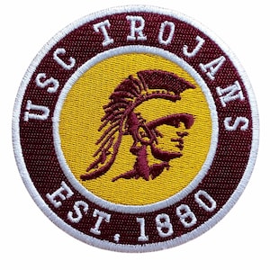 May include: Circular embroidered patch featuring the USC Trojans logo. The design includes a maroon and gold color scheme, with the words "USC TROJANS EST. 1880" encircling a Trojan warrior head.