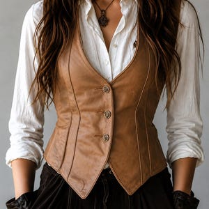 May include: A brown leather vest with three decorative buttons. The vest is worn over a white button-down shirt. The image shows a close-up of the vest, highlighting its tailored design and the texture of the leather.