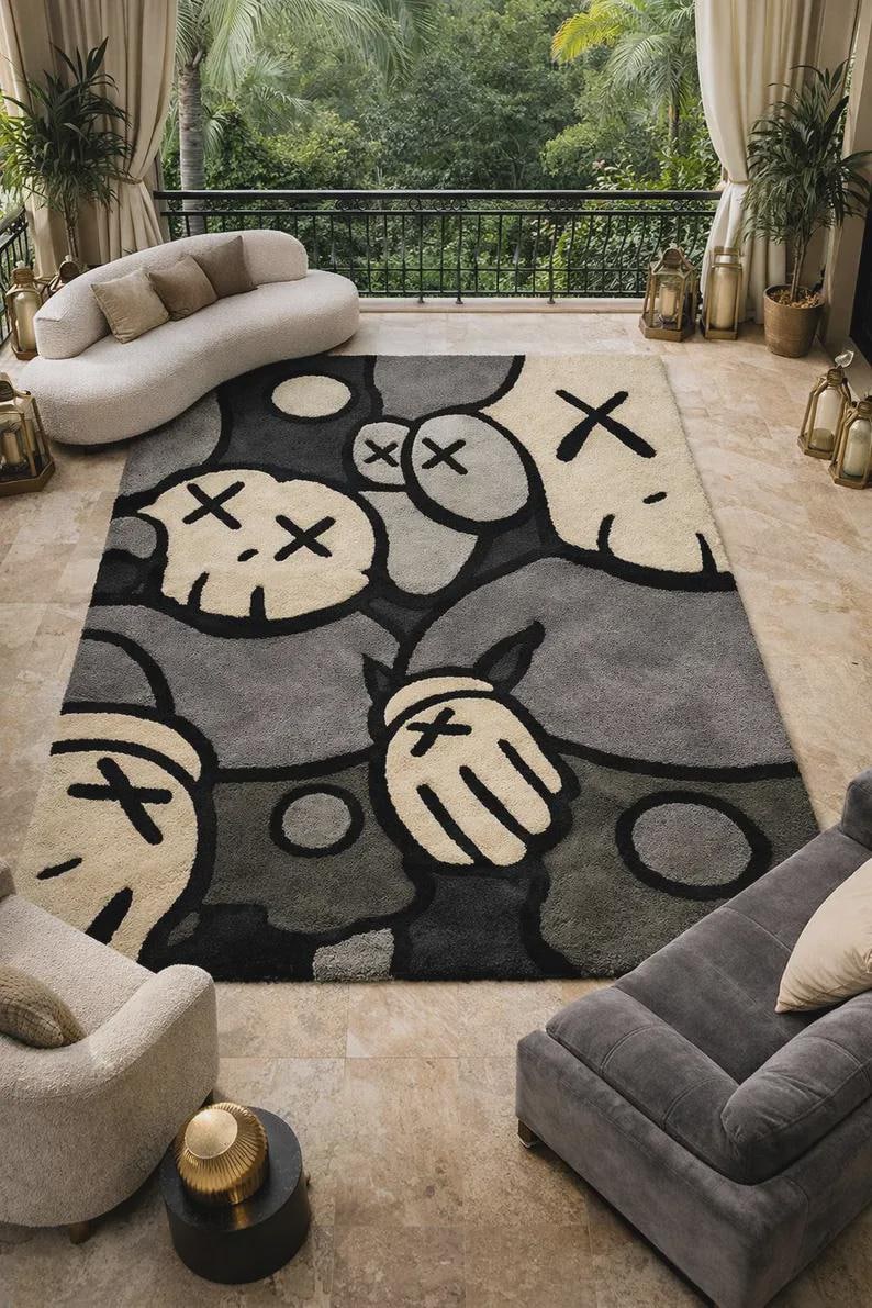 May include: A rectangular area rug featuring a repeating graphic pattern of stylized cartoon characters with X-shaped eyes and gloved hands. The design uses a palette of charcoal gray, light gray, and cream, with bold black outlines defining the shapes.