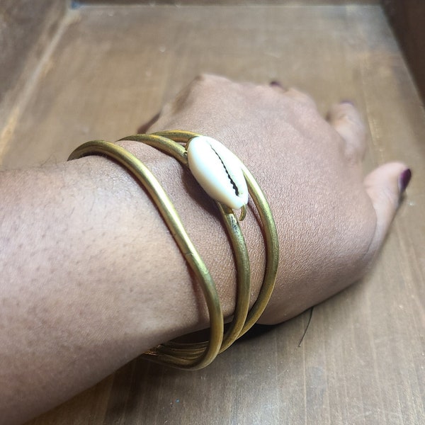 Lamu handmade African single cowrie shell and brass cuff bracelet with an adjustable back