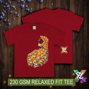 May include: A deep red short-sleeved t-shirt featuring a vibrant graphic of a peacock with gold and blue plumage. The shirt displays a gold logo on the side and a small brand tag at the neckline. The text 230 GSM RELAXED FIT TEE is visible.