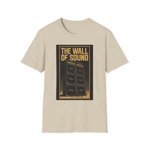May include: Beige t-shirt with a gold graphic of a stack of Marshall amplifiers and the text "THE WALL OF SOUND". The design is centrally placed on the front of the shirt, offering a striking visual.