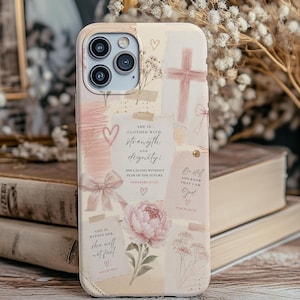 May include: A phone case with a collage design in soft pink and cream tones. The case features a cross, a peony, hearts, and text from Proverbs and Psalms. The case has a camera cutout and is decorated with a bow.