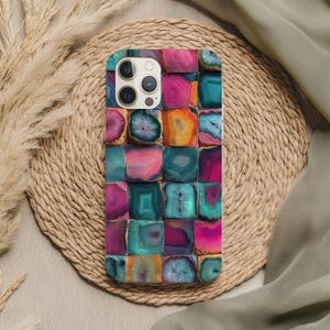 May include: A colorful phone case featuring a mosaic design of square-cut agate stones. The stones display a variety of colors, including pink, teal, orange, and purple. The case has a glossy finish and is designed to fit a smartphone.
