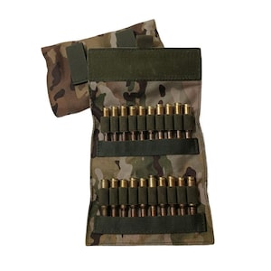 May include: Camouflage-patterned ammunition pouch with rows of brass-cased bullets. The pouch has a green flap and straps, and a smaller pouch is attached. The background is white.