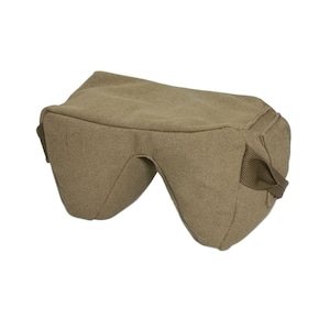 May include: A tan-coloured shooting rest bag with a saddle shape. The bag has a rectangular top and two curved sides with a cutout in the centre. It features two small fabric loops on the sides.