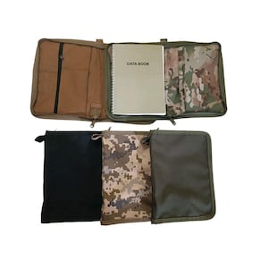 May include: An open tactical data book case with a spiral-bound notebook labelled "DATA BOOK". The case is tan with a black zipped pocket. Below are three zipped pouches in black, camouflage, and olive green.