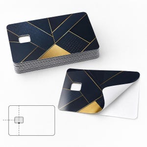 May include: A stack of navy blue and gold geometric design cards with a square cutout. One card is peeled back, revealing a white underside. The design features gold lines and shapes on a dark blue background.