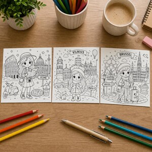 K&ouml;nnte beinhalten: Drei Schwarz-Wei&szlig;-Malvorlagen mit Illustrationen von M&auml;dchen in Rom, Vilnius und Br&uuml;ssel. Die Seiten sind von Buntstiften, einem Stift und einer Kaffeetasse umgeben, was auf eine kreative Aktivit&auml;t hindeutet. Metrische Ma&szlig;e.