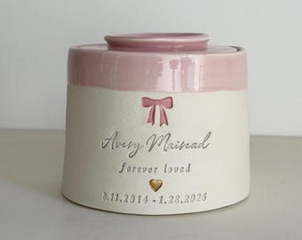 Custom infant urn pink with bow shown: largest sizes, tapered shape urn.  vitrifiedstudio