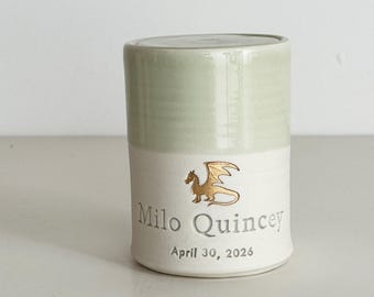 Personalized infant urn shown with dragon stamp