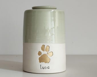 Custom cremation pet urn shown with large custom paw stamp