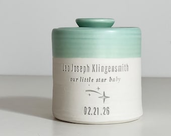 Personalized infant urn shown with shooting star stamp