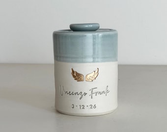 Personalized infant urn with optional gold wings shown