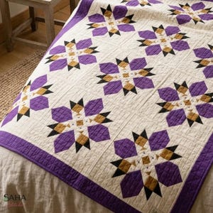 May include: A quilted bedspread featuring a repeating star pattern in shades of purple, mustard yellow, and black on a cream-colored background. The fabric is stitched with a grid-like texture throughout the entire surface of the quilt.