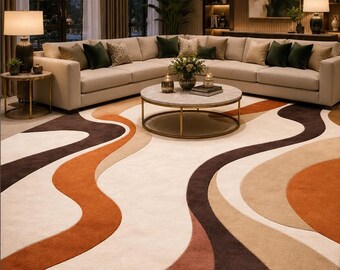 May include: A modern living room featuring a large beige sectional sofa, a round coffee table, and a patterned rug. The rug has a cream background with flowing, organic shapes in shades of brown, orange, and beige. The room is well-lit with lamps and a chandelier.