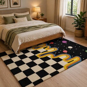May include: A bedroom scene featuring a wooden bed with neutral bedding and a green throw. A black rug with a checkerboard pattern and a colorful, wavy design sits on the wooden floor. The room has a warm, inviting atmosphere.
