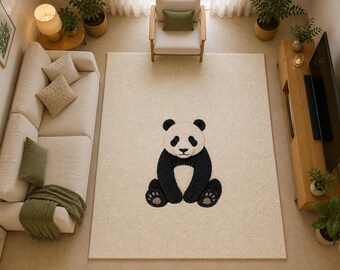 May include: A cream-colored area rug featuring a large, seated panda bear design in black and white. The rug is placed in a living room setting, surrounded by furniture and decor, including a sofa, chair, and wooden entertainment center.