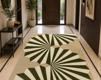 May include: A rectangular area rug featuring a repeating geometric pattern of dark green and cream-colored fan-shaped motifs. The design consists of radiating lines that form circular segments across a solid light beige background surface.