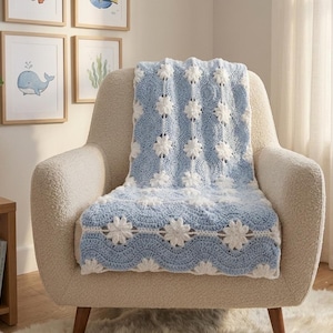 May include: A rectangular crochet blanket featuring a repeating pattern of light blue wavy stripes and white floral motifs. The textile is crafted with a textured stitch, showcasing a consistent design of alternating blue waves and white flowers.