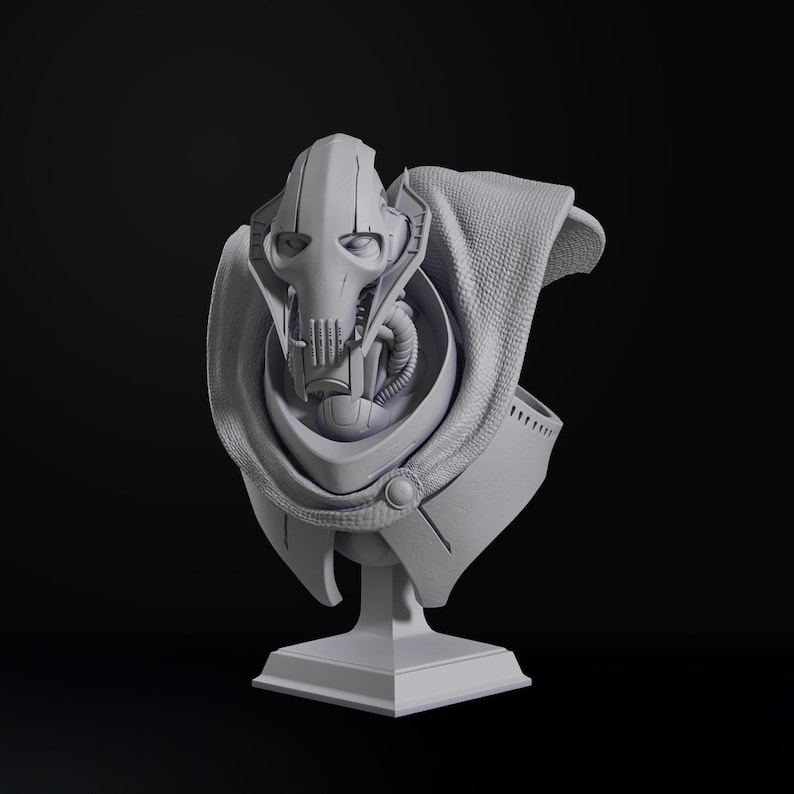 May include: A gray bust of a character with a distinctive helmet and mechanical features, set against a dark background. The bust includes a cape-like garment and is mounted on a square pedestal. The overall design suggests a science fiction or fantasy theme.