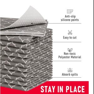 May include: A stack of gray and white patterned fabric sheets. The sheets have anti-slip silicone points, are easy to cut, made of non-toxic polyester material, and absorb spills. The text "STAY IN PLACE" is at the bottom.