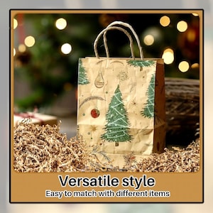 May include: A brown paper gift bag with a Christmas tree design, featuring green trees and ornaments. The bag has rope handles and is surrounded by shredded paper. The text on the image reads: "Versatile style. Easy to match with different items."